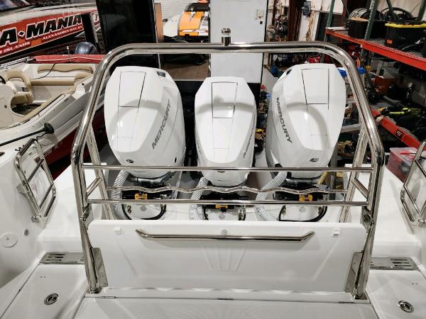 Slide: The Image of 2024 Wellcraft 355 Commuter with triple Mercury outboard engines in a showroom. - 10