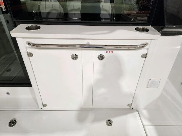 Slide: The Image of 2024 Wellcraft 355 Commuter boat interior storage compartment with stainless steel rail. - 14
