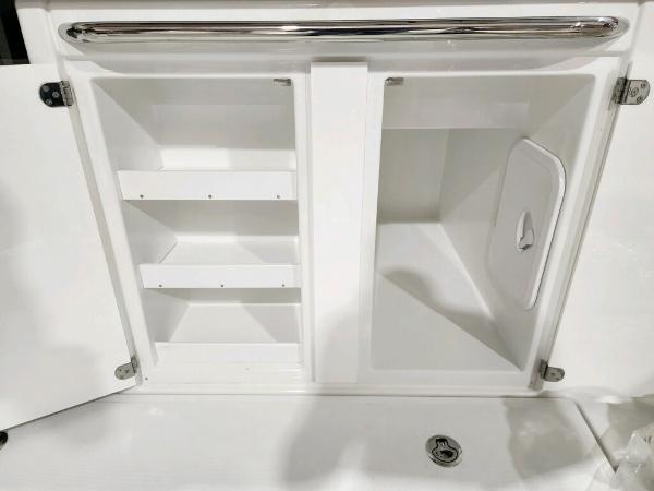 Slide: The Image of 2024 Wellcraft 355 Commuter storage compartments with shelves and hatch. - 15