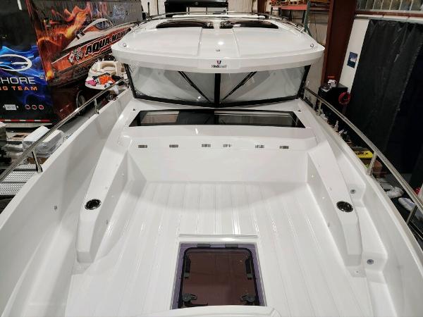 Slide: The Image of 2024 Wellcraft 355 Commuter boat interior, spacious deck, modern design. - 16