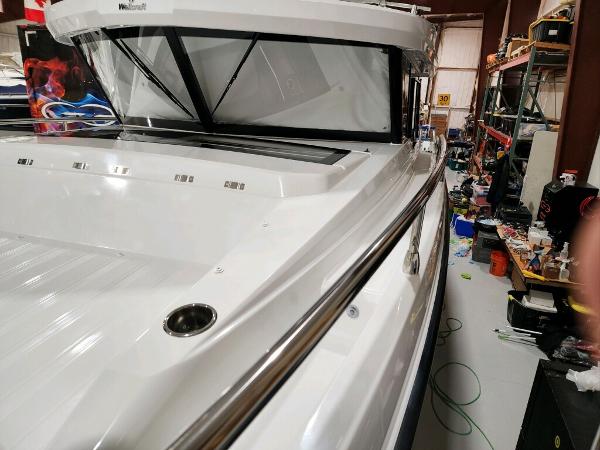 Slide: The Image of 2024 Wellcraft 355 Commuter boat in a workshop, side view. - 19