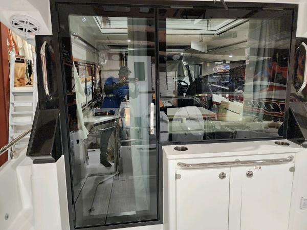 Slide: The Image of 2024 Wellcraft 355 Commuter boat interior with sliding glass door and modern design. - 25