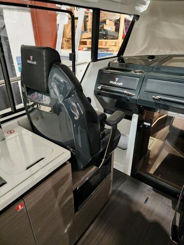 Slide: The Image of 2024 Wellcraft 355 Commuter boat interior with captain's chair and control panel. - 28