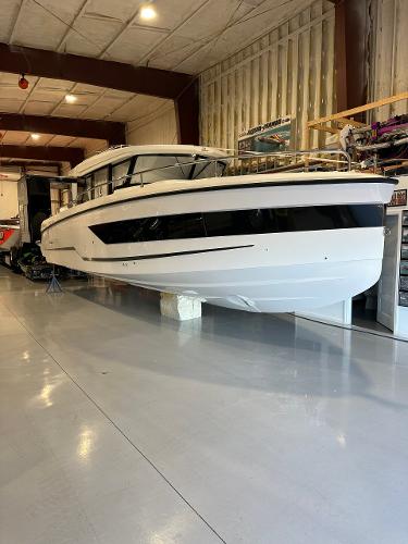 Slide: The Image of 2024 Wellcraft 355 Commuter boat in a showroom. - 3
