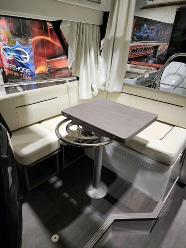 Slide: The Image of 2024 Wellcraft 355 Commuter interior seating area with table. - 30