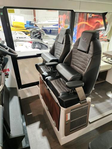 Slide: The Image of 2024 Wellcraft 355 Commuter boat interior with dual captain's chairs. - 32
