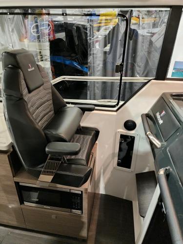 Slide: The Image of Interior of 2024 Wellcraft 355 Commuter boat with captain's chair and control panel. - 35