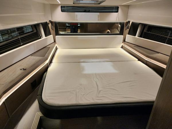 Slide: The Image of 2024 Wellcraft 355 Commuter cabin with spacious bed and modern interior design. - 42