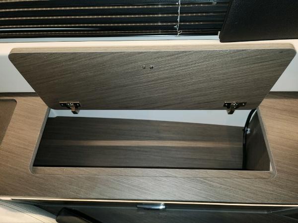 Slide: The Image of Open storage compartment in 2024 Wellcraft 355 Commuter boat interior. - 51
