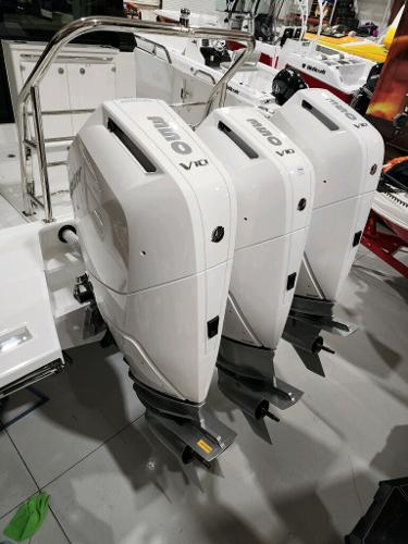 Slide: The Image of 2024 Wellcraft 355 Commuter with triple outboard engines in a showroom. - 9
