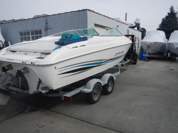 Slide: The Image of 2000 Wellcraft EXCALIBUR boat on a trailer in a marina. - 1