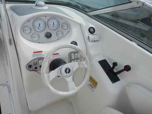 Slide: The Image of Wellcraft EXCALIBUR 2000 boat dashboard with steering wheel and control panel. - 15
