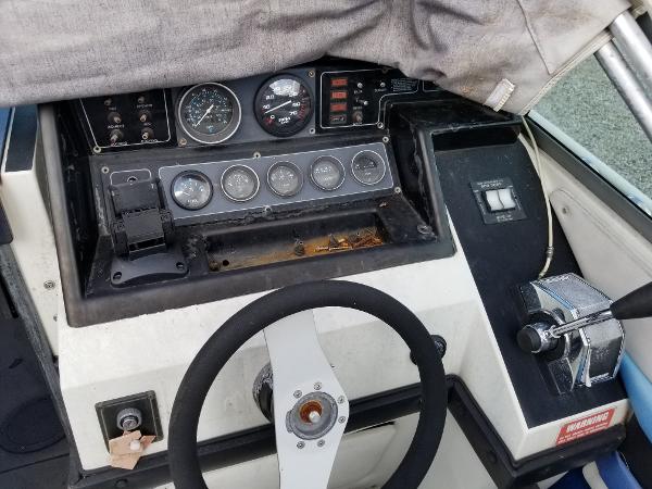 Slide: The Image of 1988 Wellcraft 23 NOVA XL boat dashboard with steering wheel and control panel. - 1