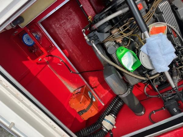 Slide: The Image of 1987 Wellcraft Nova Spyder 26 engine compartment with red interior and visible engine components. - 11