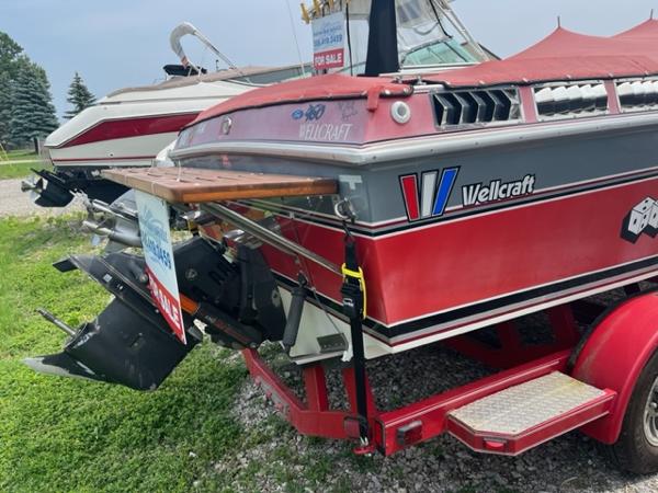 Slide: The Image of 1987 Wellcraft Nova Spyder 26 boat on trailer, red and white, for sale. - 3