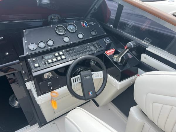 Slide: The Image of 1987 Wellcraft Nova Spyder 26 boat cockpit with steering wheel and control panel. - 5