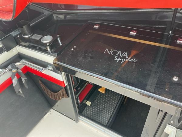 Slide: The Image of 1987 Wellcraft Nova Spyder 26 boat interior with black and red accents. - 6