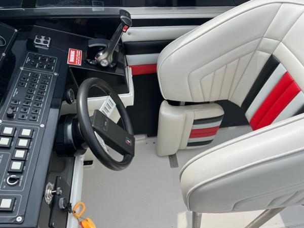 Slide: The Image of 1987 Wellcraft Nova Spyder 26 cockpit with steering wheel and control panel. - 8