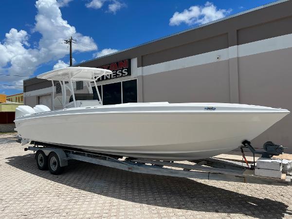 Slide: The Image of 1979 Wellcraft Scarab Sport 302 boat on a trailer, parked outdoors under a blue sky. - 1