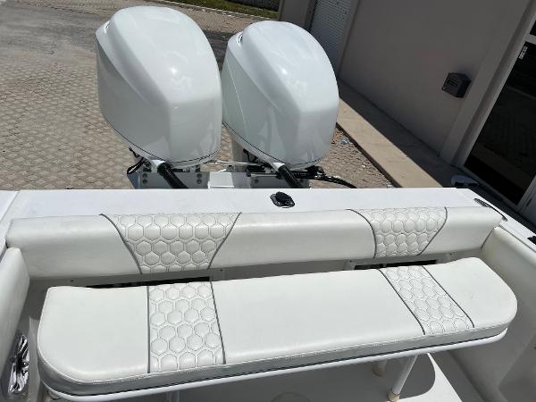 Slide: The Image of 1979 Wellcraft Scarab Sport 302 boat with twin outboard engines and white cushioned seating. - 13