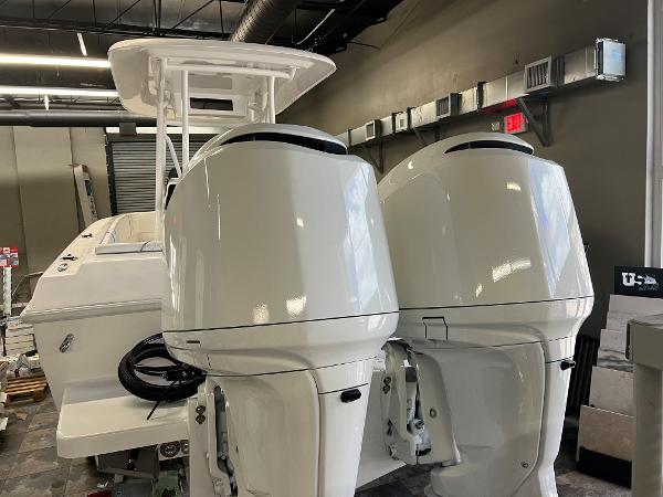Slide: The Image of 1979 Wellcraft Scarab Sport 302 with dual outboard motors in a showroom. - 43