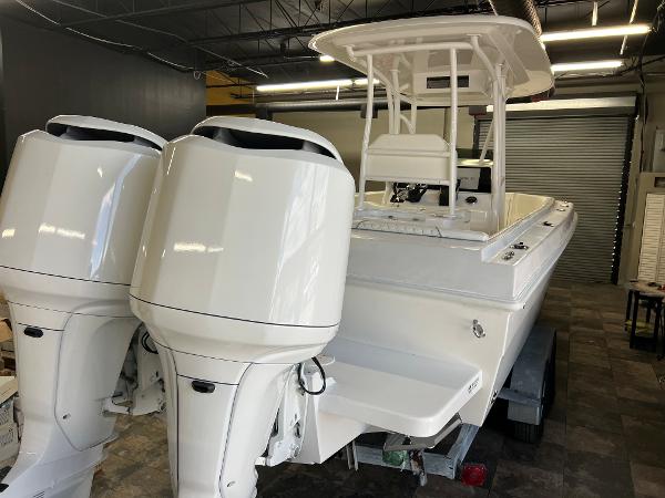 Slide: The Image of 1979 Wellcraft Scarab Sport 302 with twin outboard engines in a garage. - 44