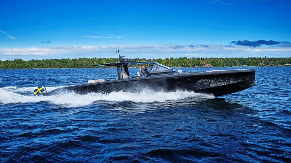 Slide: The Image of 2024 Windy SRL/SR60 boat cruising on a lake with a forested shoreline. - 0