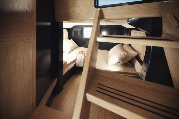 Slide: The Image of 2024 Windy SRL/SR60 yacht interior cabin with wooden finish and cozy bedding. - 11
