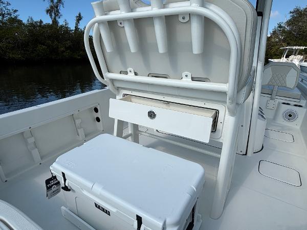 Slide: The Image of 2025 World Cat 235 CC boat interior with storage and cooler on deck. - 16