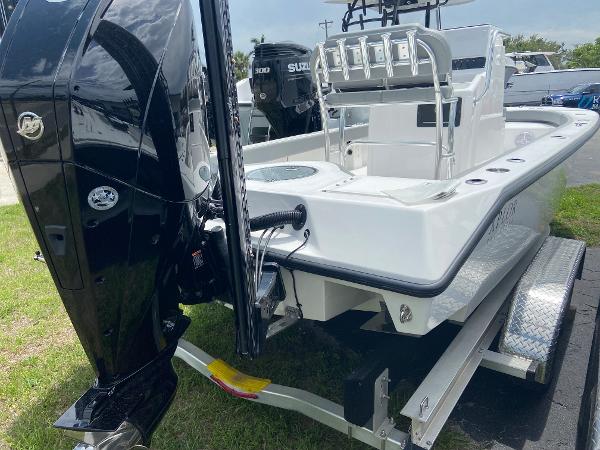 Slide: The Image of 2023 Xplor x24 Andros boat on trailer, rear view with outboard motor. - 11
