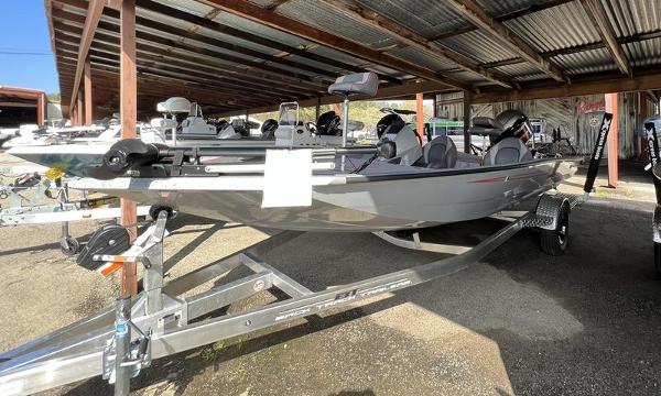 Slide: The Image of 2023 Xpress H18 fishing boat on a trailer under a metal canopy. - 1