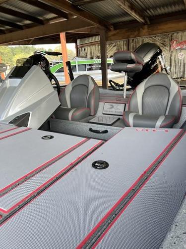 Slide: The Image of 2023 Xpress H18 boat interior with gray and red seating and storage compartments. - 2