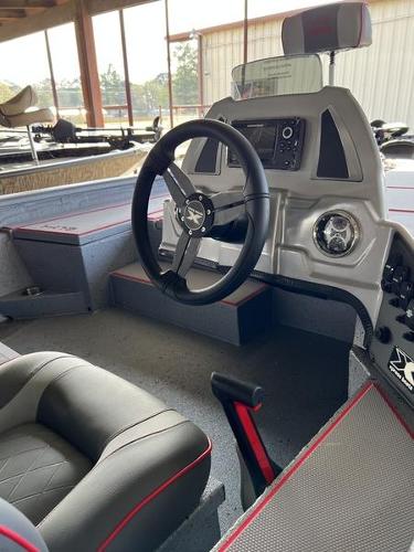 Slide: The Image of 2023 Xpress H18 boat interior with steering wheel and control panel. - 6