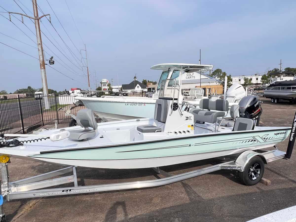 Slide: The Image of 2024 Xpress H20B Hyper-Lift Bay boat on a trailer in a dealership lot. - 1