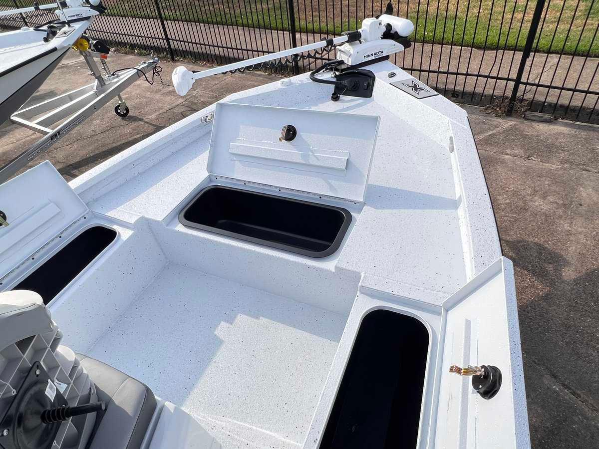 Slide: The Image of 2024 Xpress H20B HYPER-LIFT BAY boat with open storage compartments. - 10