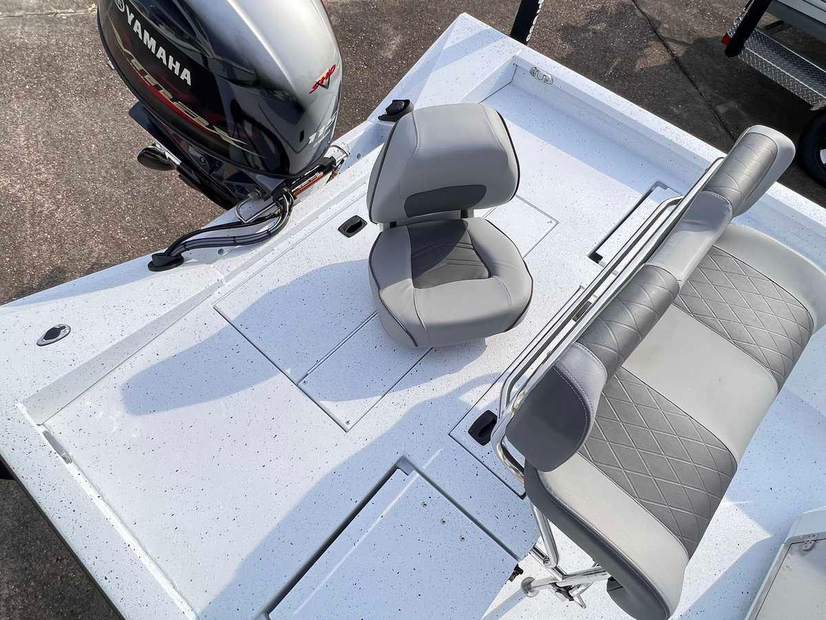 Slide: The Image of 2024 Xpress H20B Hyper-Lift Bay boat with Yamaha engine and gray seating. - 2