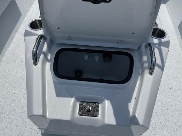 Slide: The Image of Open storage compartment on 2025 Xpress H22B boat with cup holders and handles. - 10