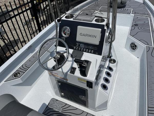 Slide: The Image of 2025 Xpress H22B boat console with Garmin navigation system and steering wheel. - 11