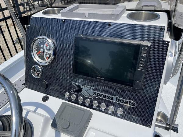 Slide: The Image of Dashboard of 2025 Xpress H22B boat with gauges and touchscreen display. - 13