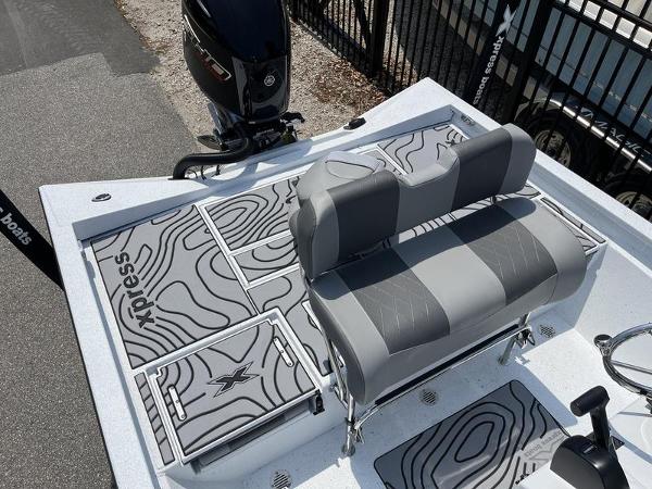 Slide: The Image of 2025 Xpress H22B boat with gray seating and patterned deck design. - 15