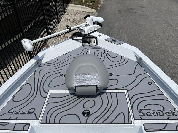 Slide: The Image of 2025 Xpress H22B boat deck with SeaDek flooring and trolling motor. - 5