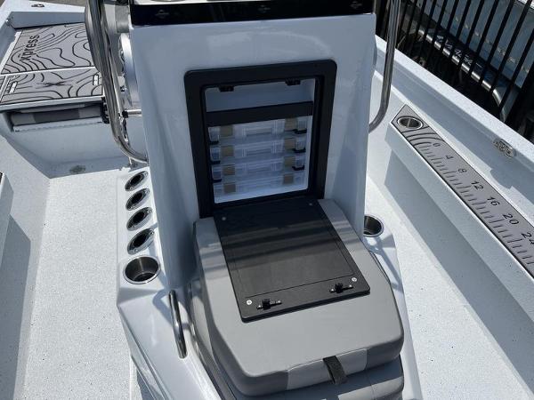 Slide: The Image of 2025 Xpress H22B boat console with storage compartments and measuring ruler. - 9