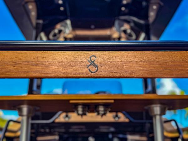 Slide: The Image of Close-up of 2023 X Shore Eelex 8000 boat's wooden detail with logo. - 11