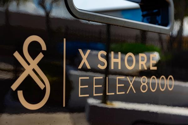 Slide: The Image of 2023 X Shore Eelex 8000 logo on boat exterior. - 18