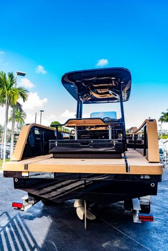 Slide: The Image of 2023 X Shore Eelex 8000 electric boat, rear view, docked under clear blue sky. - 19