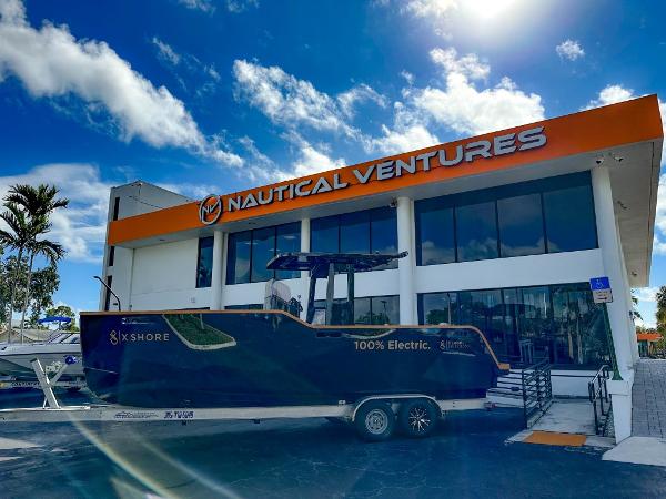 Slide: The Image of X Shore Eelex 8000 electric boat outside Nautical Ventures dealership, 2023 model. - 2