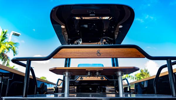 Slide: The Image of 2023 X Shore Eelex 8000 electric boat, rear view with wooden details and blue sky background. - 22