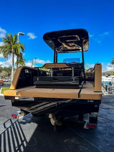 Slide: The Image of 2023 X Shore Eelex 8000 electric boat, rear view, docked under a clear blue sky. - 5
