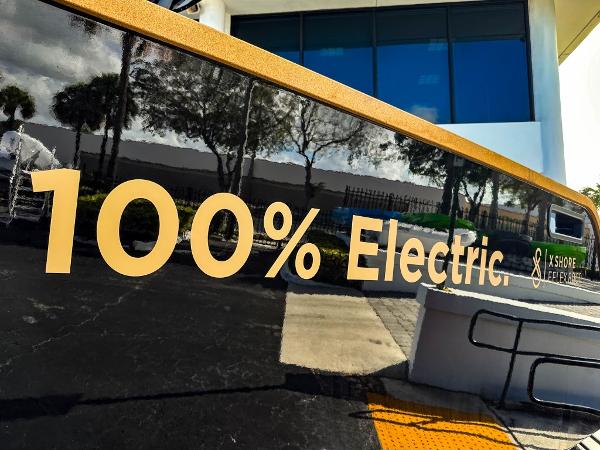 Slide: The Image of 2023 X Shore Eelex 8000 electric boat with '100% Electric' sign. - 6