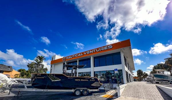 Slide: The Image of X Shore Eelex 8000 electric boat outside Nautical Ventures dealership, 2023 model. - 8